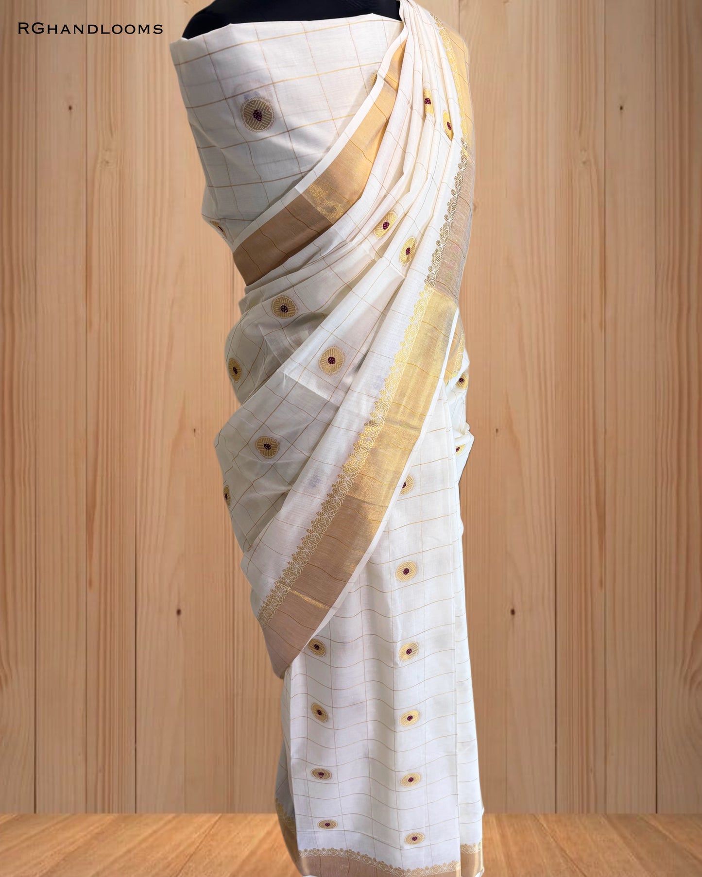 handloom saree featuring a timeless checked design paired with bold red buttas