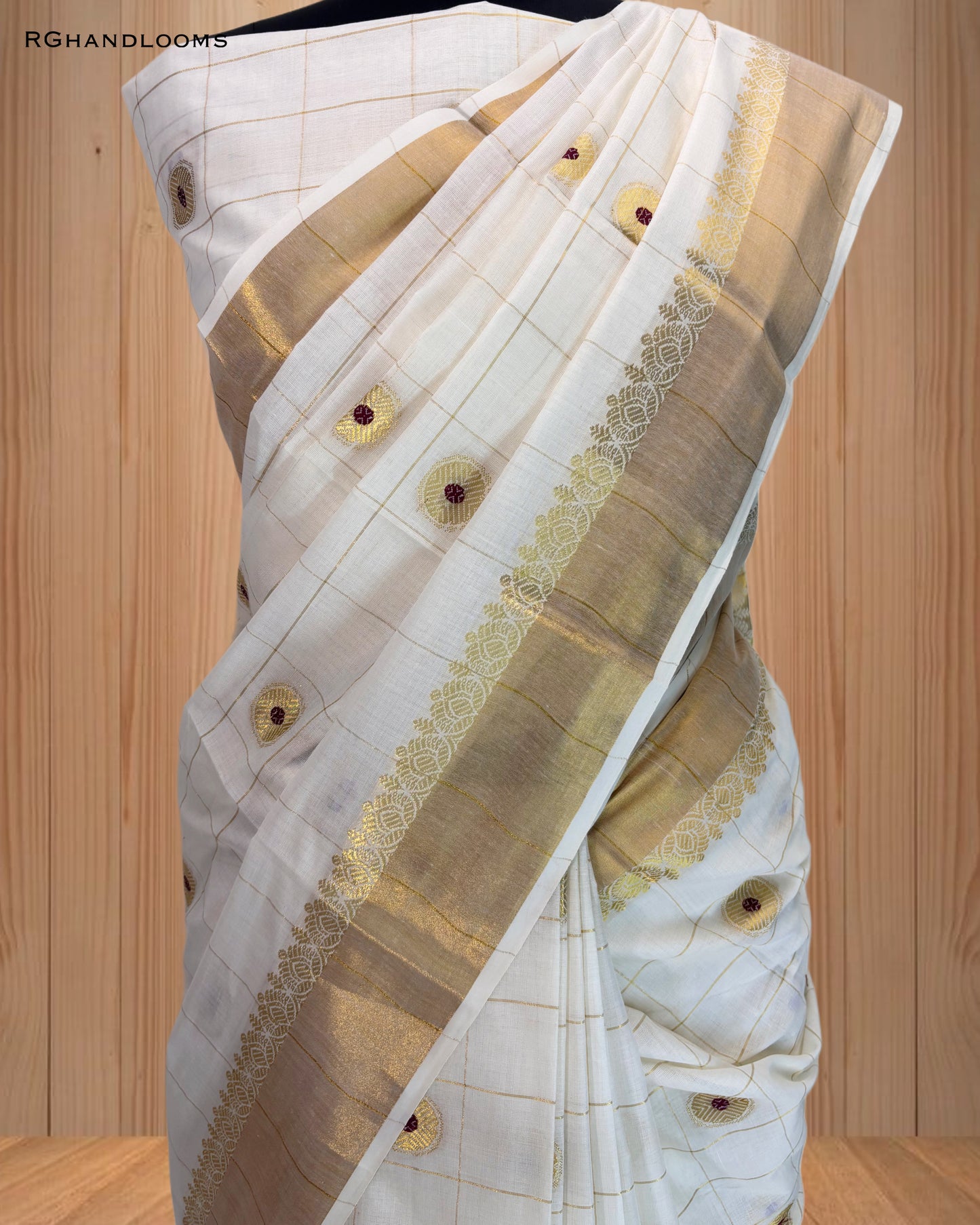 handloom saree featuring a timeless checked design paired with bold red buttas