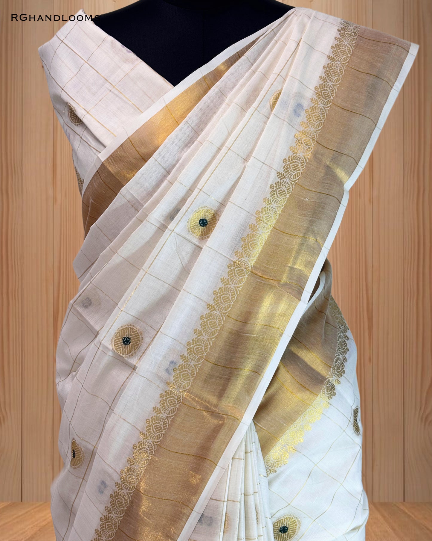 handloom saree featuring a classic checked design with green buttas